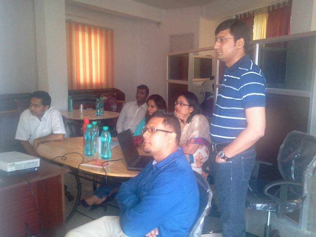 Colleagues gathered around a table in a Bangalore coworking office